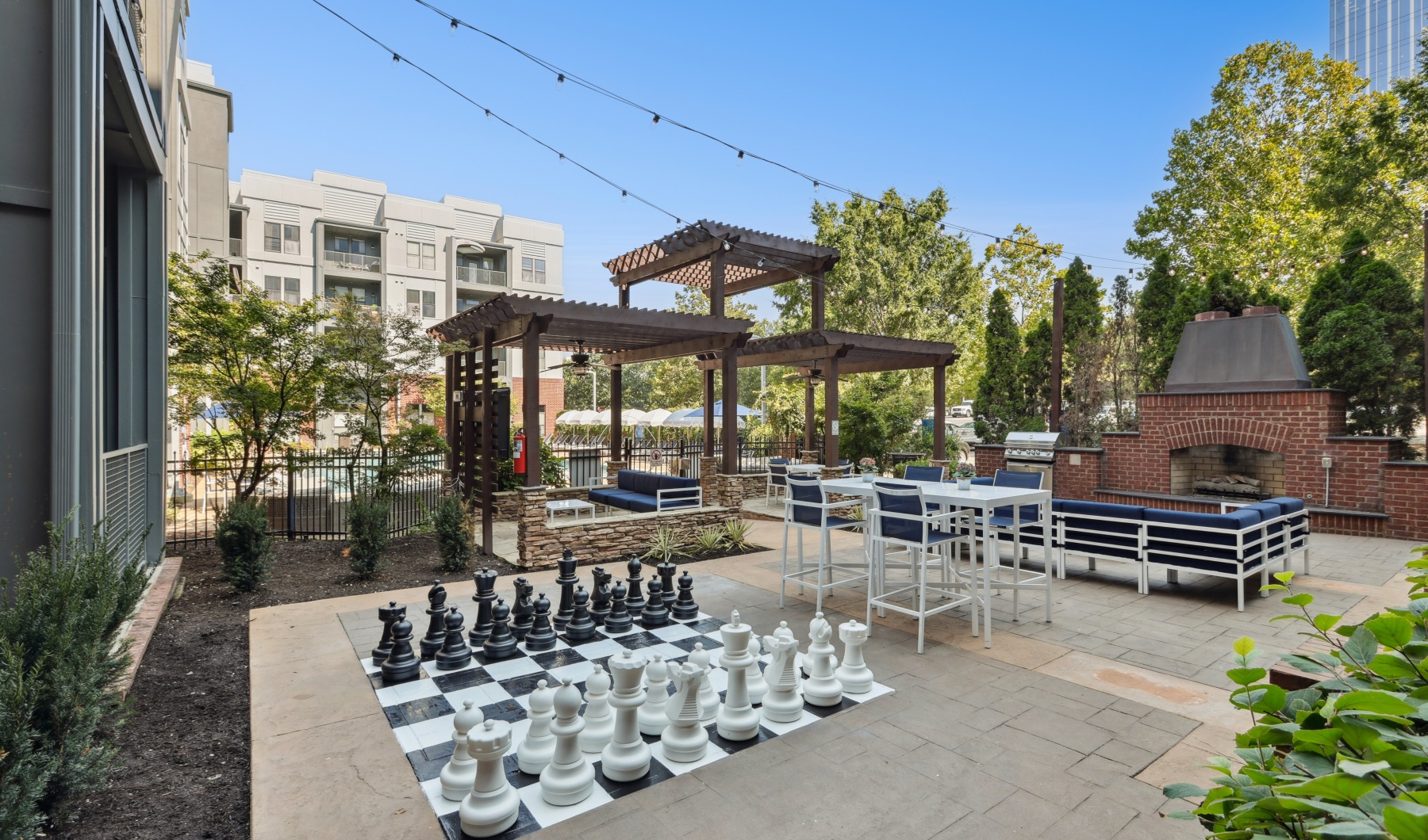 outdoor lounge with large chess board, seating and outdoor fireplace outdoor lounge with large chess board, seating and outdoor fireplace